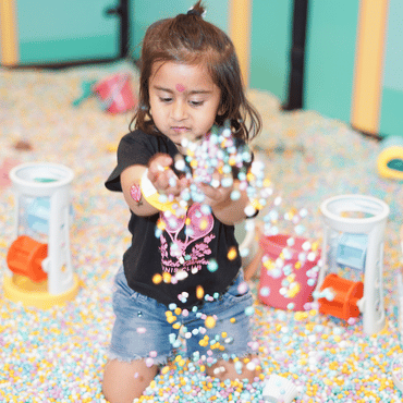 Children playing in the ball pit at a Wooray soft play zone