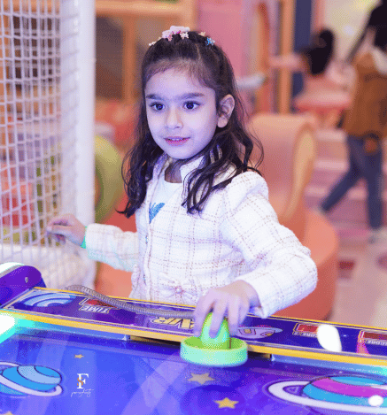 A child enjoying the bumper car ride at Wooray's indoor play area